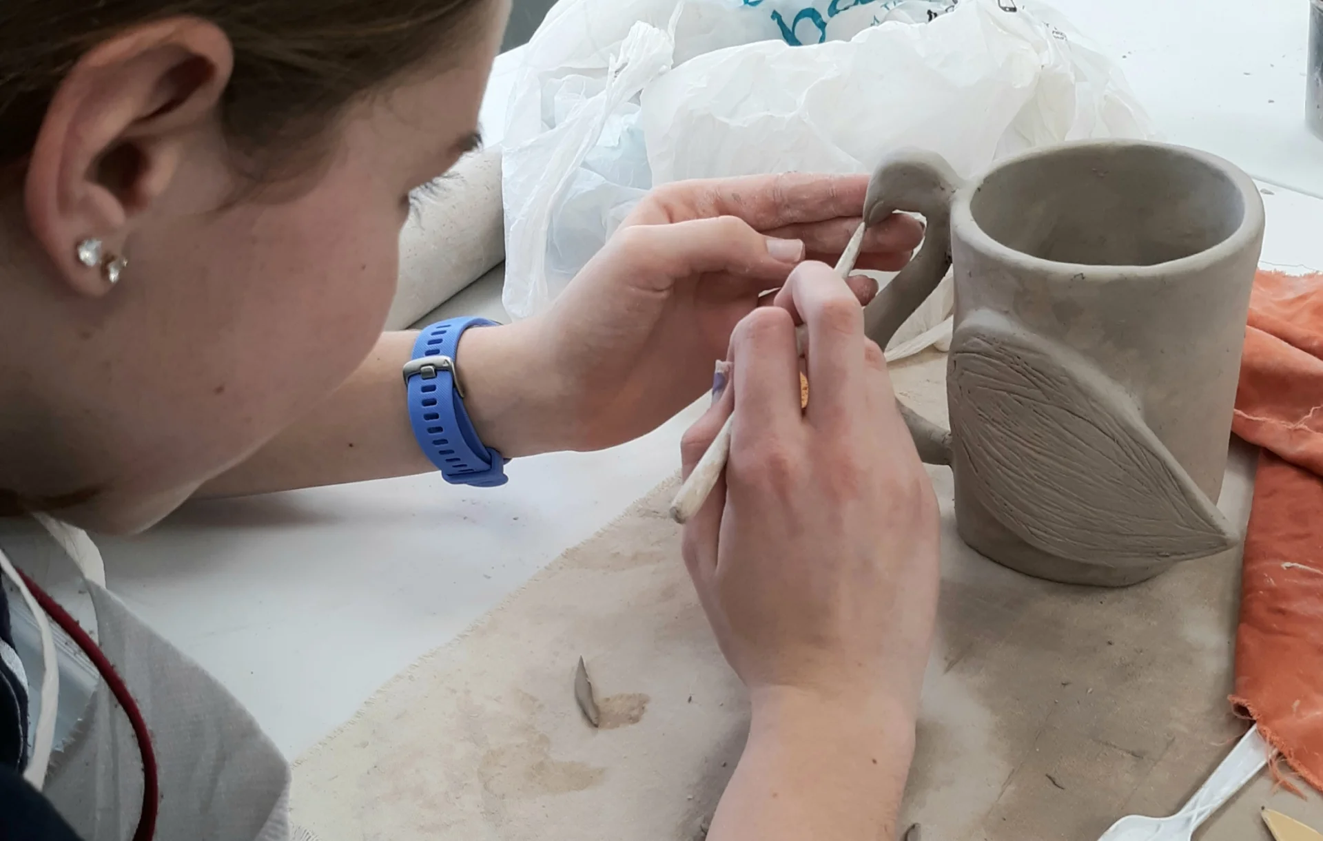 student working on pottery