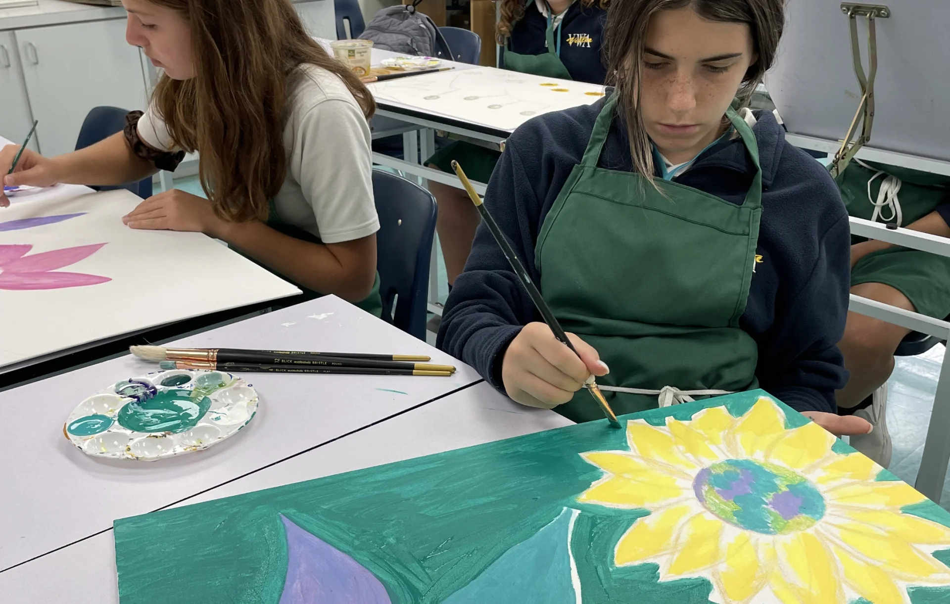 two students painting