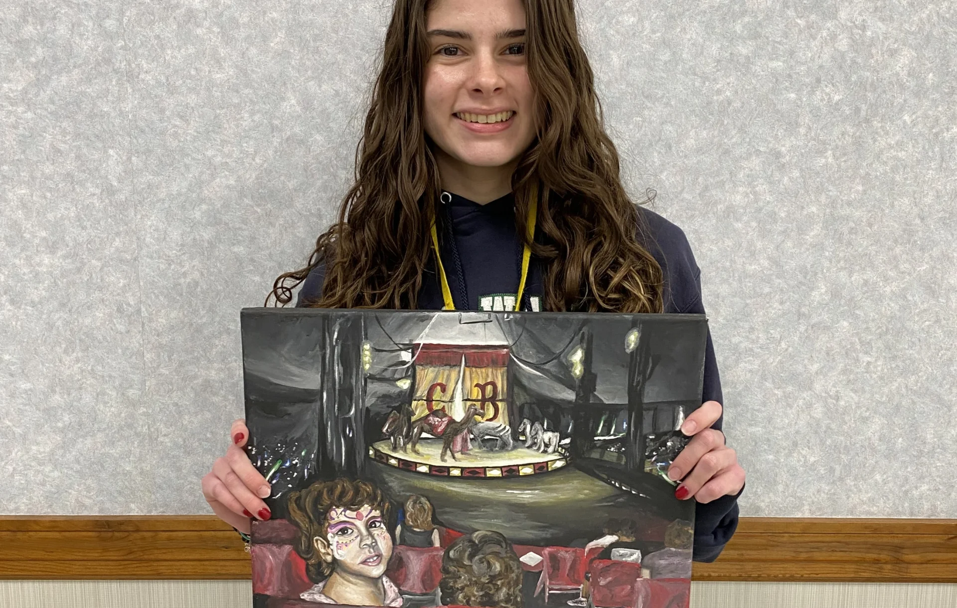 student holding their artwork