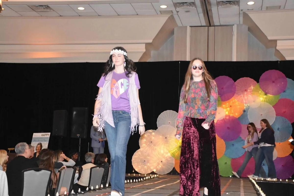 two students walking down the runway