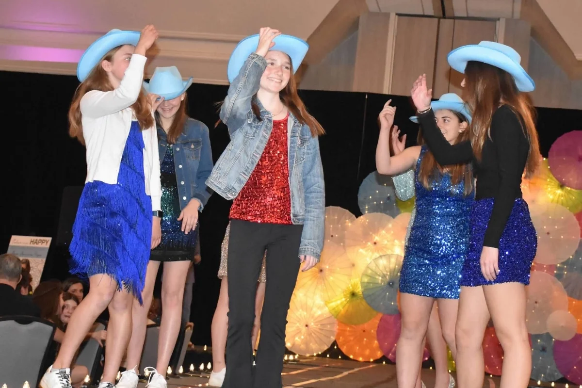 five students in sparkly outfits and cowboy hats