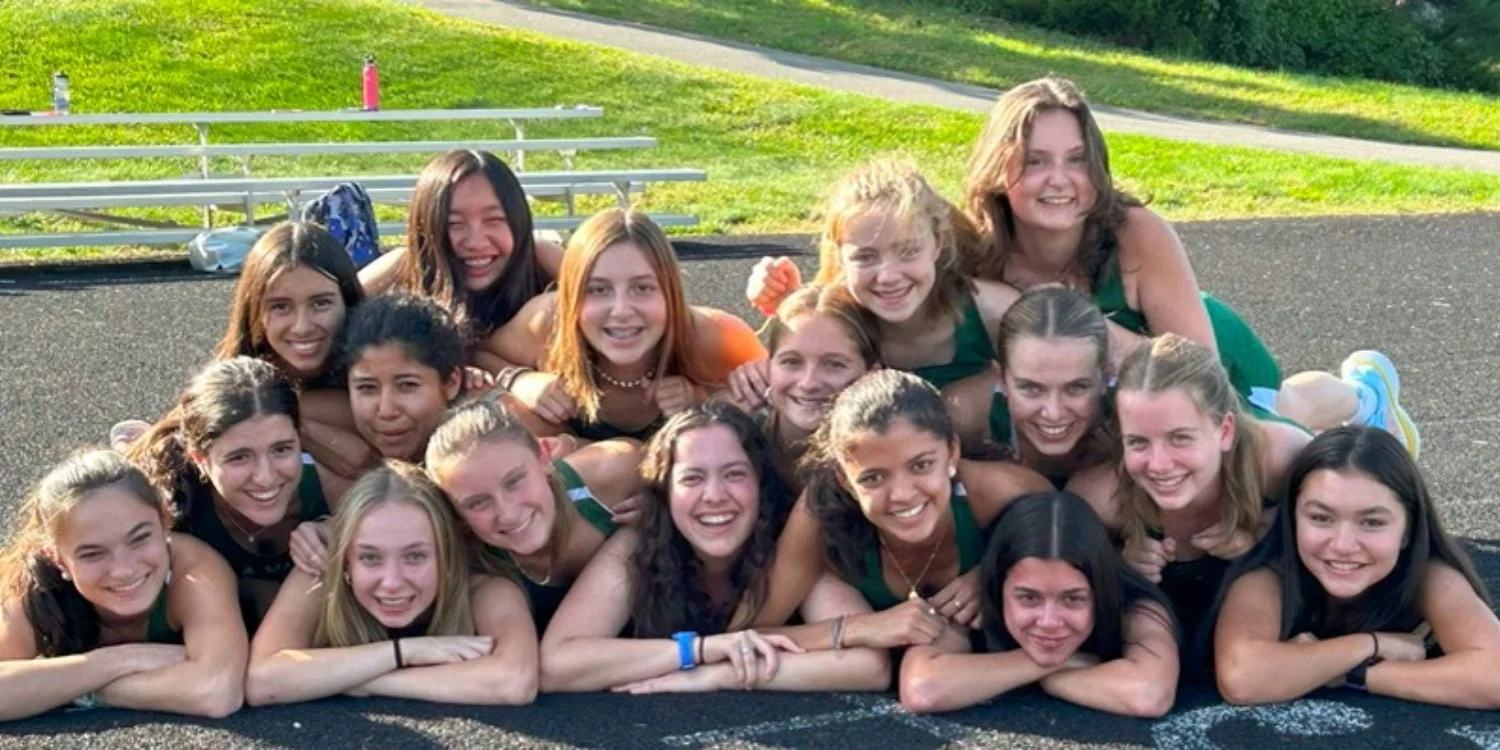 cross country team laying on the track