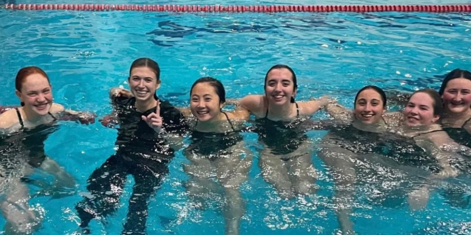 VWA swim team in the water smiling