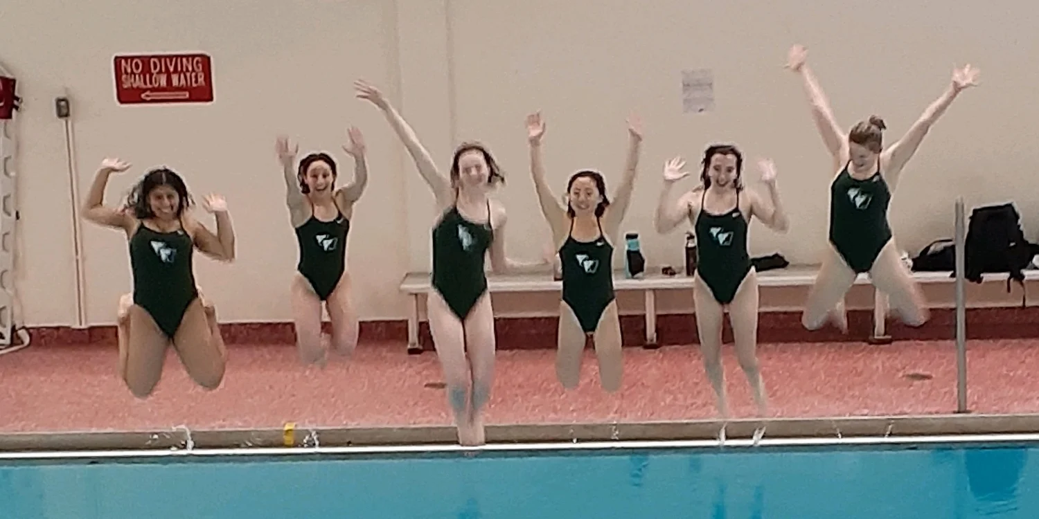 VWA swim team members jumping into pool