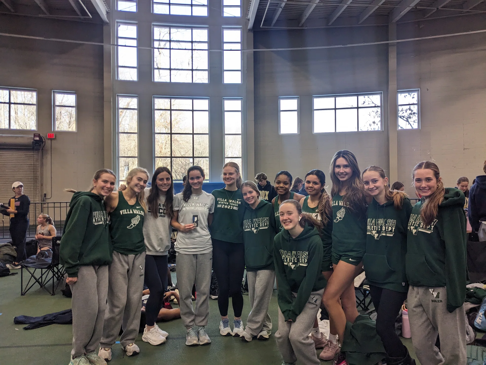 Cliff Back Invitational - December 2024 - Team photo with alumnae Jesse Kramer and Jackie Walsh: Maggie Boler breaks 800m school record (and the meet record) with a time of 2:17. 