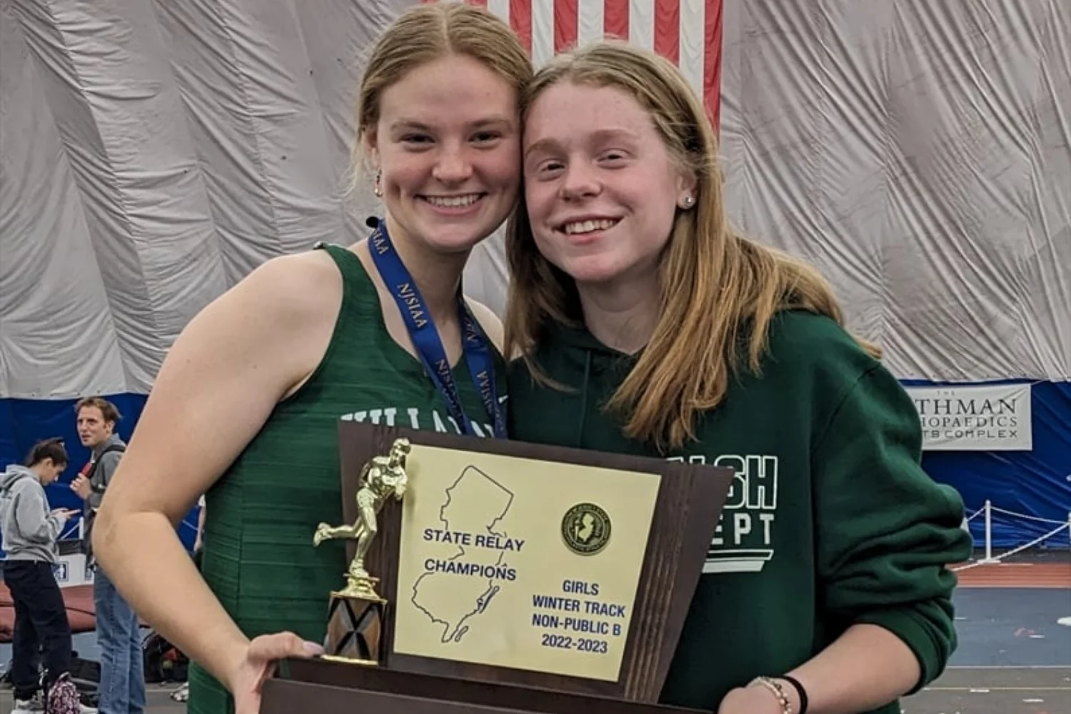 winter track team captains holding award