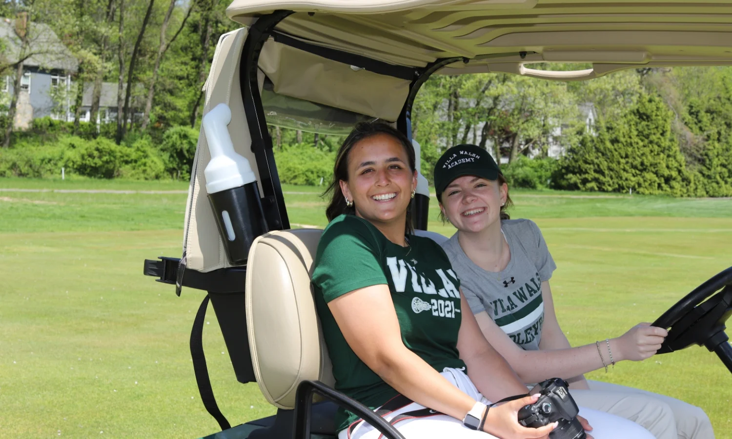 2 VWA students in a golf cart