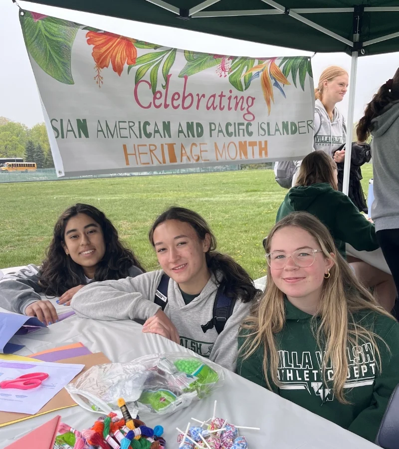 students sitting in AAPI Heritage Month tent