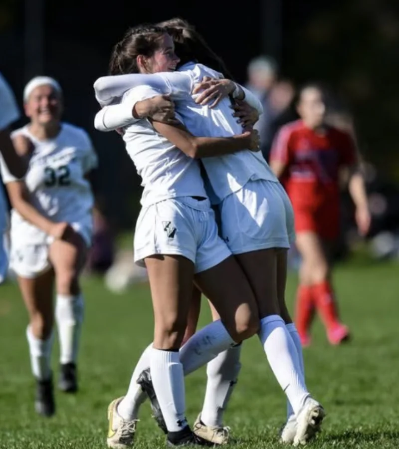 two VWA soccer players hugging