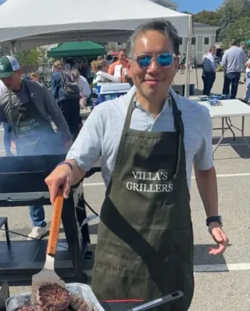 booster club member grilling burgers